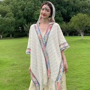 Women bohemian knitted hooded shawl tassel poncho travel wear detail view showing ethnic pattern