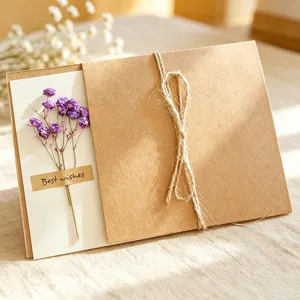 Vintage handmade kraft paper greeting card with purple dried flowers for festival wishes.