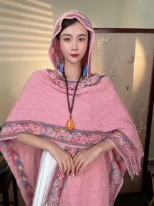 Detailed view of the stylish pink knitted hooded shawl with ethnic patterns and soft texture.