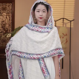 Women's knitted hooded shawl with colorful crochet trim, elegant bohemian style cape detail.