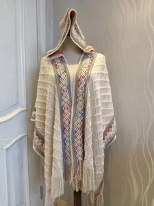 Fashionable women knitted hooded poncho cape with ethnic style cozy winter tassel details