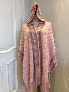 Stylish pink hooded knitted poncho with fringe, ethnic pattern, cozy winter wrap shawl.