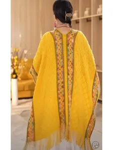 Detail view of a stylish ethnic knit hooded cape for women, cozy and versatile for travel.