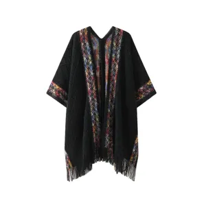 Detailed view of women black knit shawl with colorful ethnic trim and stylish fringe edge.