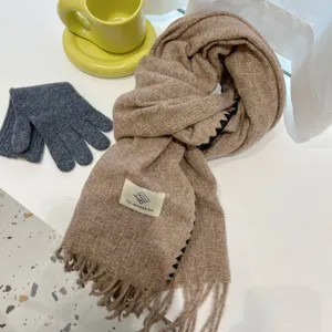Details of the thick warm winter scarf with stylish fringe and knit texture for women.