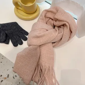 Cozy pink plaid tassel winter scarf with dark gray warm knit gloves for daily wear.