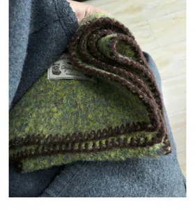 Green brown knitted scarf winter warm neck warmer cozy wool shawl retro style detail view.