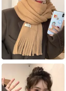 Cozy winter tassel knit scarf in camel, stylish cold-weather neck warmer accessory detail.