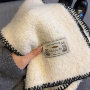 White plush winter scarf with black stitch edge, cozy knit shawl for women, warm winter neckwear.