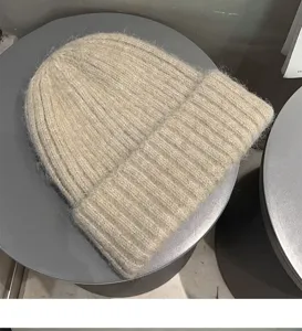 Cozy knit beanie hat for women and men, warm winter slouchy ribbed cap in stylish oatmeal color.