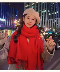 Detail view of cozy winter red knit scarf with fringe, stylish seasonal fashion street lifestyle.