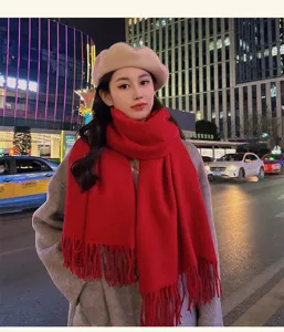 Women's winter warm red fringed scarf, thick cozy knit shawl for cold weather fashion wear.