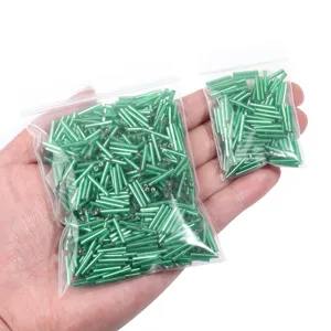 Green tubular bugle beads for DIY jewelry making, silver-lined spacer beads detail shot.