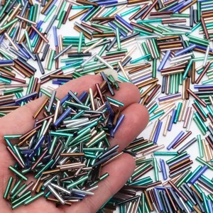 Detailed shot of 12mm colorful silver-lined bugle beads, perfect for DIY jewelry making and crafts.