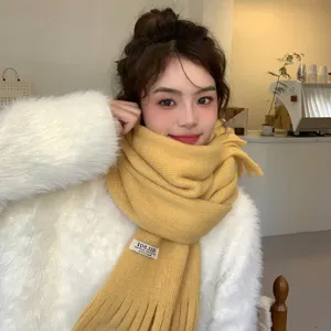 Cozy yellow knitted winter scarf with tassels, warm and stylish Korean fashion neckerchief.
