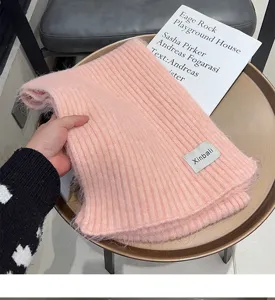 Cozy pink knitted wool scarf detail showcasing soft texture and warm winter design features.
