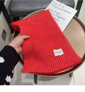 Winter red knitted scarf for women and men, cozy and warm woolen neck warmer accessory.