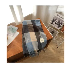 Cozy retro plaid winter scarf with chic fringe details, stylish blue and black pattern.