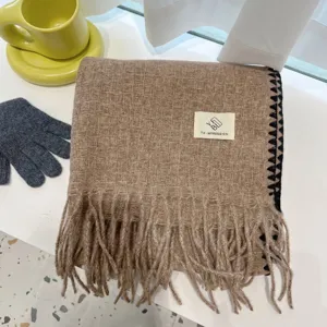 Cozy winter tassel scarf in camel with elegant texture, warm and stylish daily accessory.