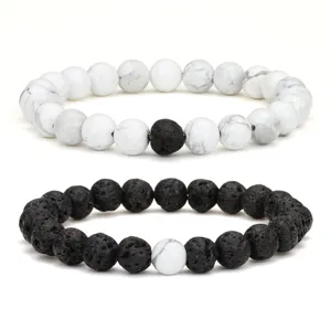 Chic black and white stone bead bracelet set featuring natural lava stone and howlite beads detail.