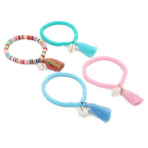 Colorful heishi clay bead bracelets with cute cowrie shell and tassel charms, stackable boho style.