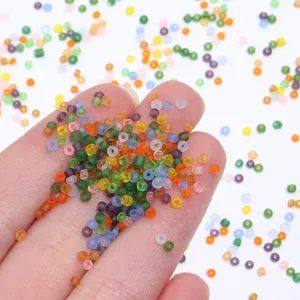 Detailed view of colorful frosted glass seed beads, 2mm small beads for DIY bracelets.