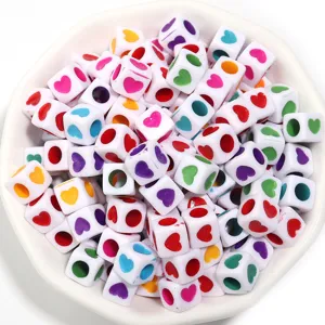 Close-up detail of colorful acrylic square heart beads, perfect for DIY jewelry making and crafts.