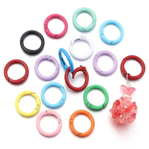 Colorful round metal spring rings, mini snap hooks, keychain accessories for DIY crafts.
