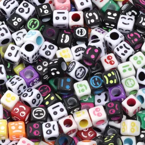 Detail shot of colorful acrylic square smiley face beads for DIY bracelet accessories.