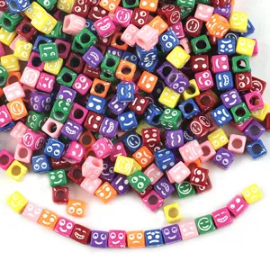 Detail view of colorful acrylic square smiley face beads for DIY jewelry making and bracelets.