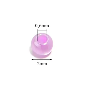Close-up detail of 2mm purple imitation jade glass seed bead with 0.6mm hole for DIY jewelry making.
