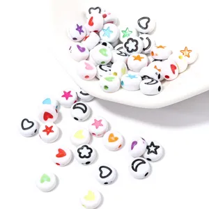 Colorful patterned acrylic spacer beads detail shot, featuring heart, star and flower designs.