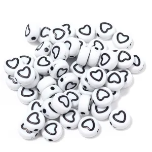 White acrylic flat round beads with black heart pattern, perfect for DIY jewelry making.