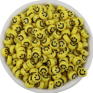 Detail shot of yellow acrylic flat round smile beads, cartoon expression loose beads for DIY.