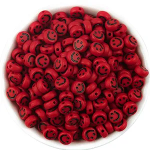 Detailed shot of red acrylic flat round smiley face beads, perfect for DIY jewelry making.