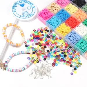Close-up view of 24-grid polymer clay beads kit with colorful discs, letter beads, and findings.