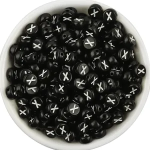 Acrylic black round letter beads with white X print for DIY bracelet jewelry making detail.
