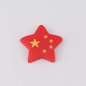 Close-up detail of the red star resin charm with yellow five-pointed stars, ideal for DIY phone case craft.