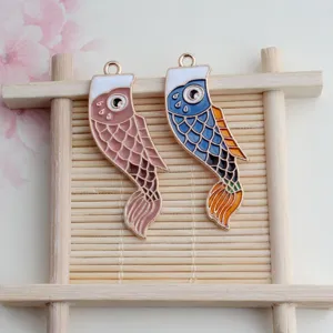 Detailed view of alloy enamel carp fish pendants in pink and blue, perfect for DIY jewelry making.