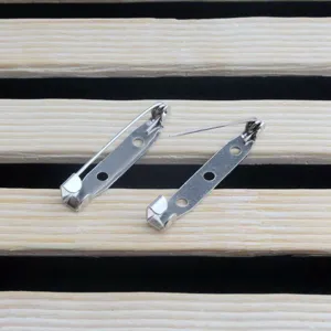 Detailed view of silver tone metal brooch pin backs for diy craft jewelry making