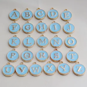 Close up of gold rim blue enamel round letter charms alphabet pendants diy jewelry making items