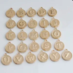 Detail view of gold-rimmed round enamel alphabet letter charms, A to Z DIY jewelry pendants.