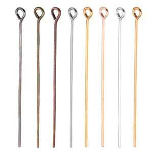Close-up detail of assorted metal eye pins for DIY jewelry making and beading connectors.