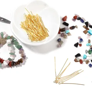 Detailed shot of gold eye pins and colorful crystal stone beads for DIY jewelry making.