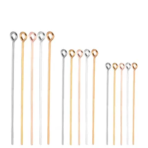 Detailed closeup view of metal eye pins for diy jewelry making and beading connecting craft.