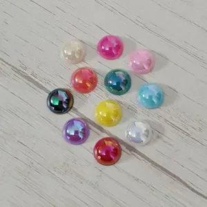 Detailed close-up of colorful acrylic cabochon flatback gems with AB cat eye effect.