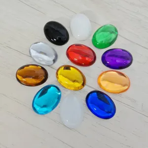 Closeup details of colorful oval flatback acrylic gems, smooth surface DIY jewelry craft accessories.