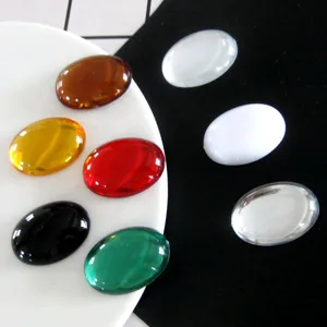 Detailed close-up of oval acrylic flatback rhinestones for DIY crafts and jewelry making.