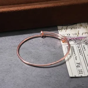 Adjustable rose gold wire bangle bracelet for women, elegant minimalist fashion jewelry.