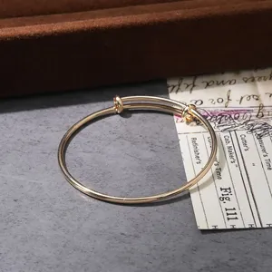 Minimalist gold adjustable wire bangle, elegant metal minimalist fashion bracelet detail.
